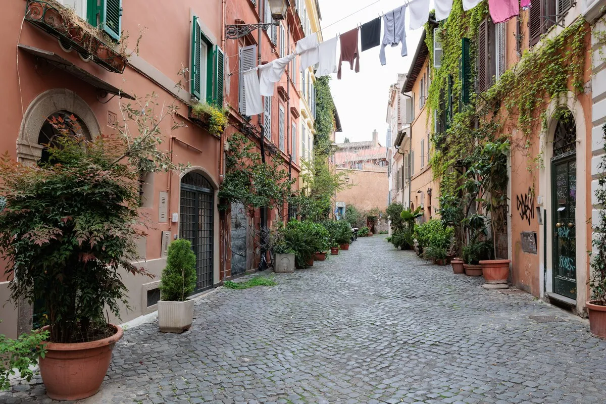 The lane outside the apartment, laundry hanging between the façades and pots along the cobbles.